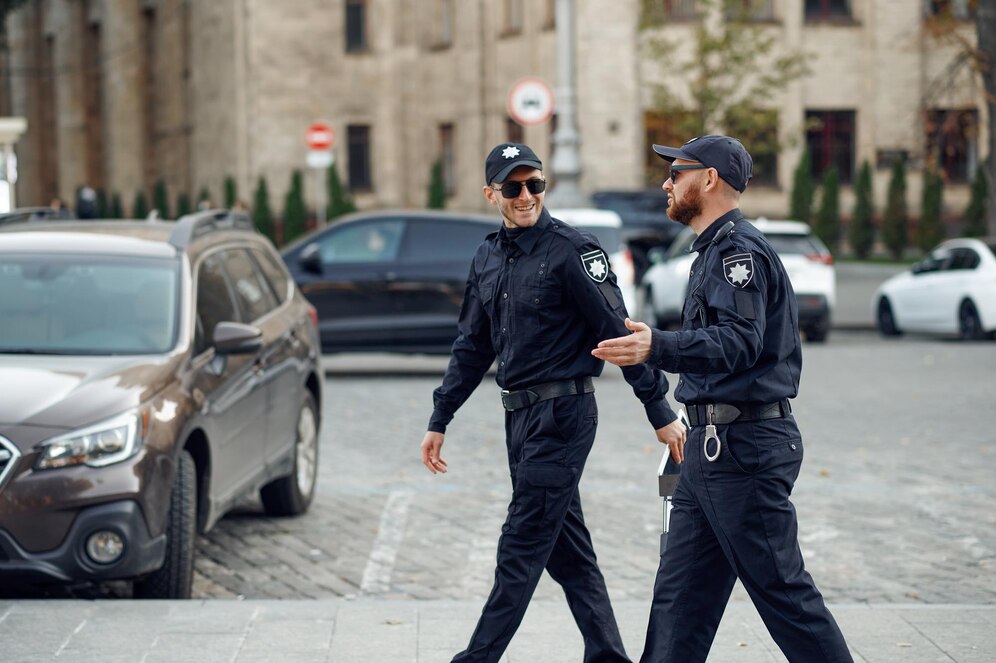 two-smiling-male-police-officers-sunglasses_266732-29819